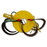 A fishing lure set featuring a bright yellow circular skirt, dark brown paddle tails, yellow and green skirt strands, and red bead accents on a white background.