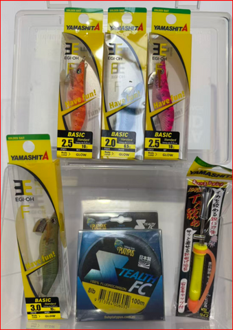 A collection of Yamasita fishing gear in their original retail packaging, including three packages of Eagle-OH lures, a package of Teah FC line, and a hookdriver tool, all arranged inside a clear plastic display tray.