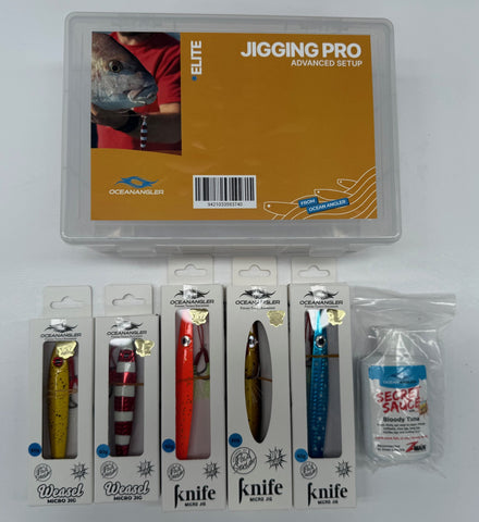 Oceanangler Jigging Pro Advanced Setup kit in a clear plastic case, displayed with five packaged fishing lures and a bottle of Secret Sauce bait on a white background.